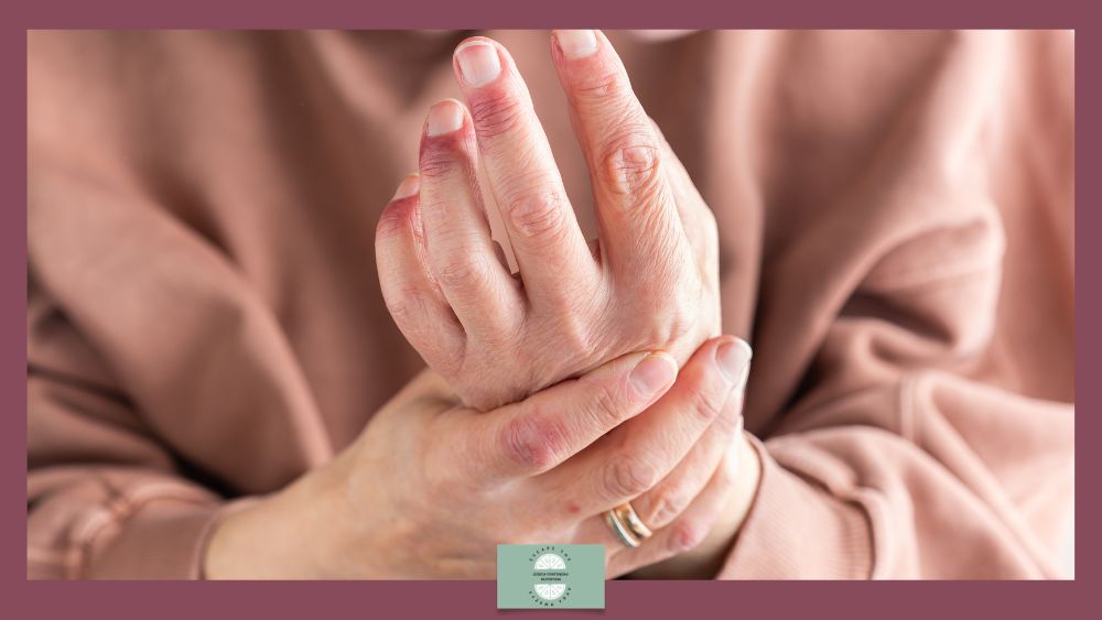 Close-up of an elderly person's hands gently rubbing or holding their wrist, with visible inflammation on hands.